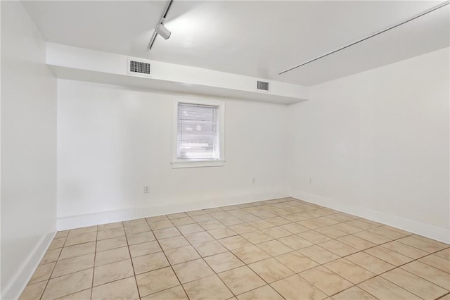 tiled empty room with track lighting