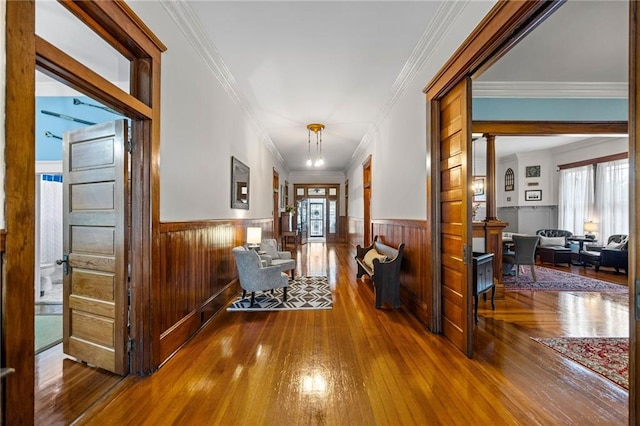 corridor featuring hardwood / wood-style flooring and crown molding