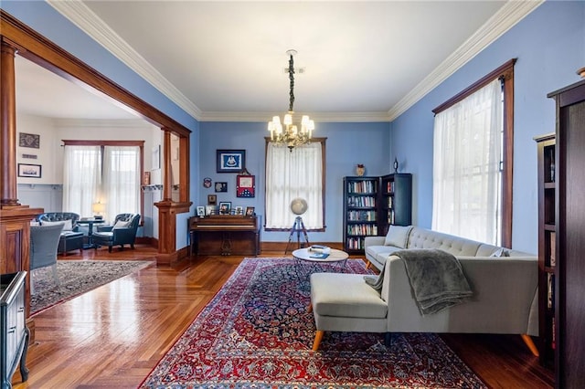 living room with ornamental molding, parquet floors, and a chandelier