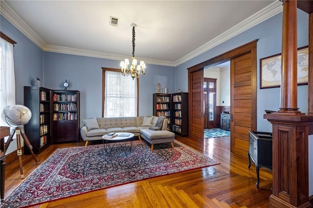 living room with crown molding, a chandelier, and parquet flooring