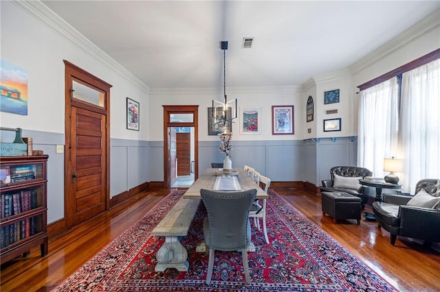 dining area featuring crown molding and dark wood-type flooring