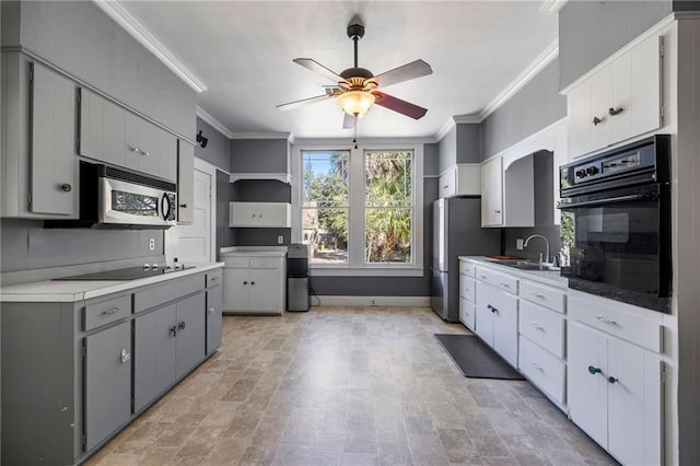 kitchen featuring gray cabinetry, sink, black appliances, and ornamental molding