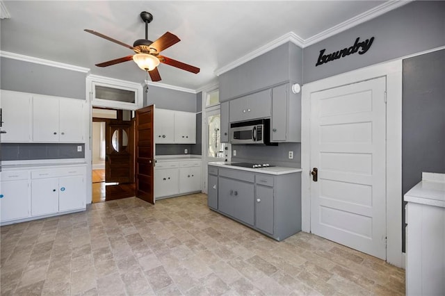 kitchen featuring gray cabinetry, black electric cooktop, ceiling fan, crown molding, and white cabinetry