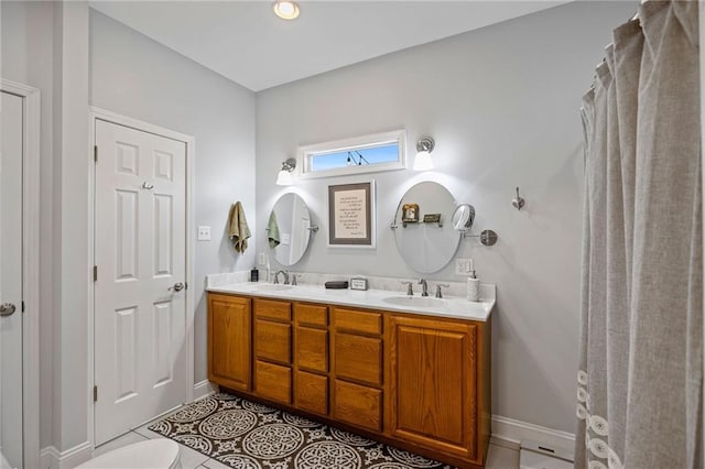 bathroom featuring tile patterned flooring and vanity