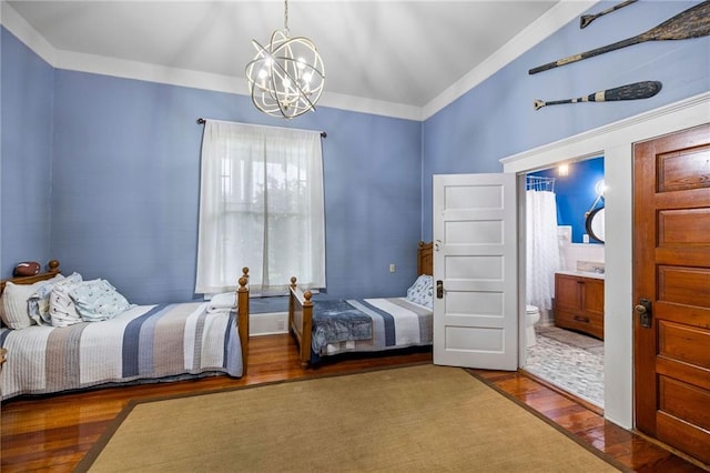 bedroom with hardwood / wood-style floors, ensuite bathroom, crown molding, and a chandelier