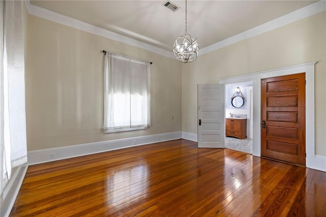 entryway featuring crown molding, a chandelier, and dark hardwood / wood-style floors