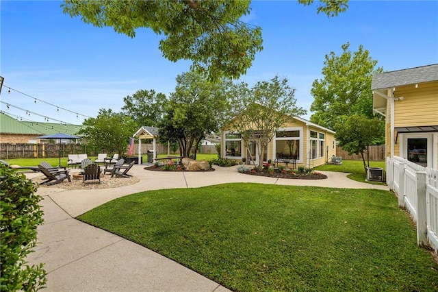 view of yard featuring a gazebo, a patio area, and a fire pit