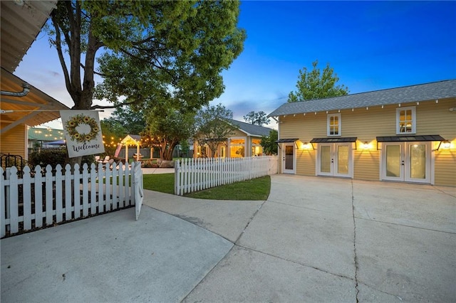 property exterior at dusk with french doors