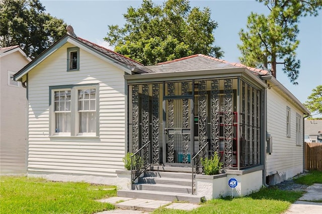 view of front of house featuring a sunroom