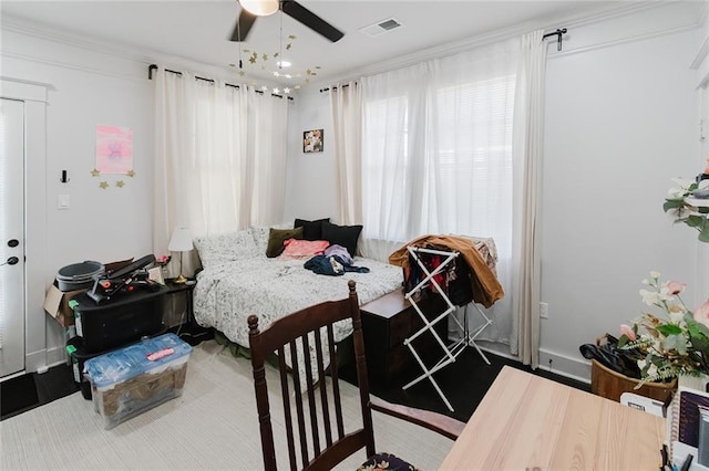 bedroom with ceiling fan and crown molding