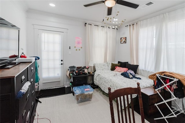 bedroom with ornamental molding and ceiling fan