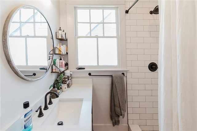 bathroom featuring a shower with curtain, vanity, and a healthy amount of sunlight