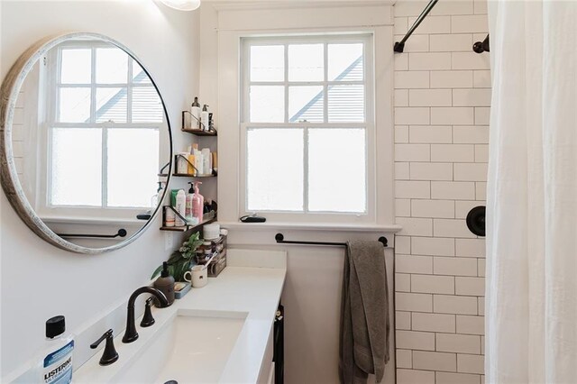 4670 Marigny St, New Orleans, LA 70122 - full bathroom featuring healthy amount of natural light, a tile shower, and vanity
