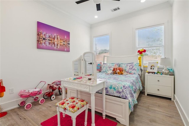 bedroom featuring light hardwood / wood-style flooring, ceiling fan, and ornamental molding