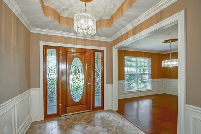 entrance foyer featuring an inviting chandelier and crown molding