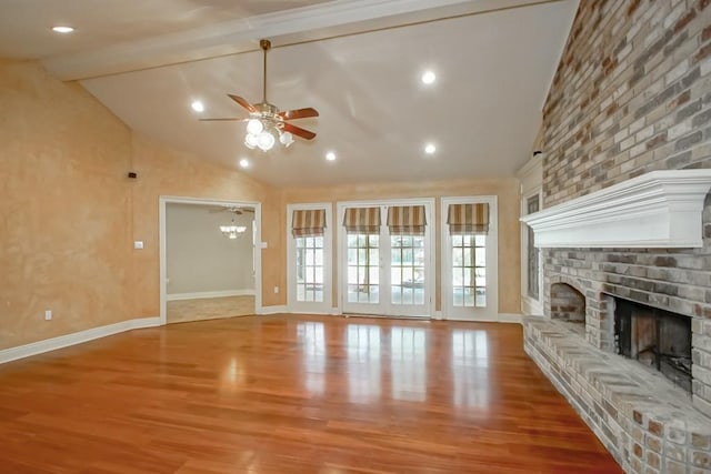 unfurnished living room with a fireplace, ceiling fan, light hardwood / wood-style flooring, and beamed ceiling