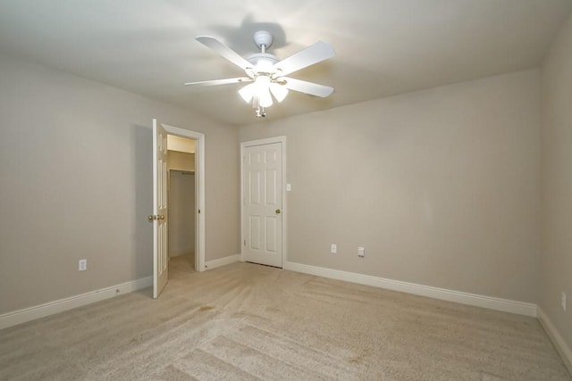 spare room featuring ceiling fan and light colored carpet