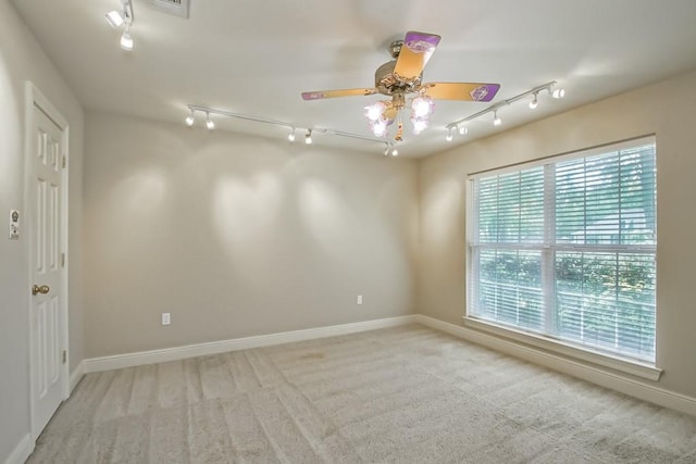 carpeted spare room with ceiling fan