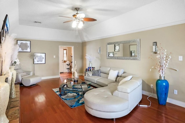 living room featuring vaulted ceiling, ceiling fan, dark hardwood / wood-style floors, and a textured ceiling