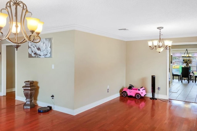 dining area with ornamental molding, hardwood / wood-style floors, and a chandelier