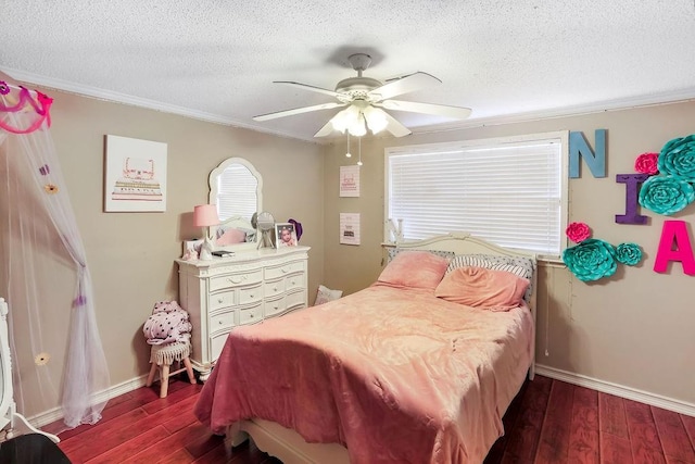 bedroom with ceiling fan, ornamental molding, a textured ceiling, and dark hardwood / wood-style flooring