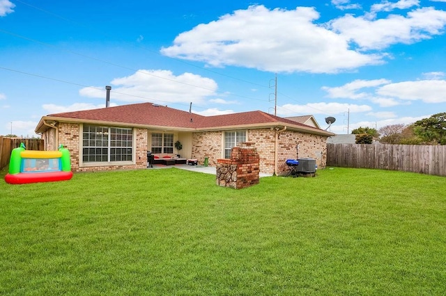 back of property featuring brick siding, an outdoor hangout area, a patio, and central AC