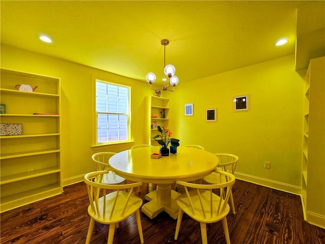 dining room featuring an inviting chandelier and dark hardwood / wood-style flooring