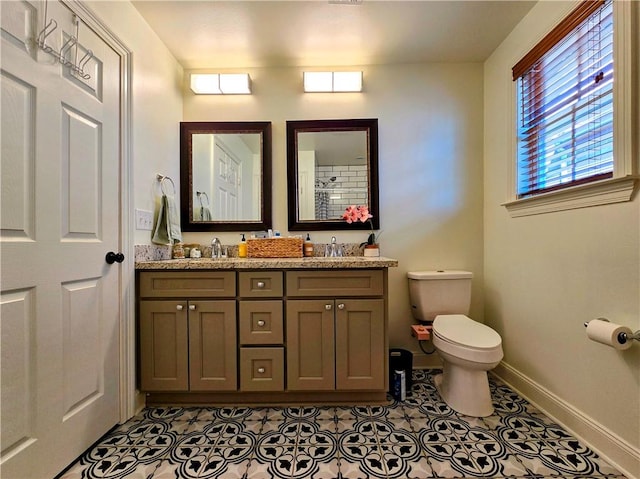 bathroom featuring vanity, tile patterned flooring, and toilet