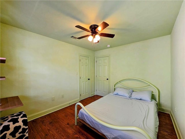 bedroom with ceiling fan and dark hardwood / wood-style flooring