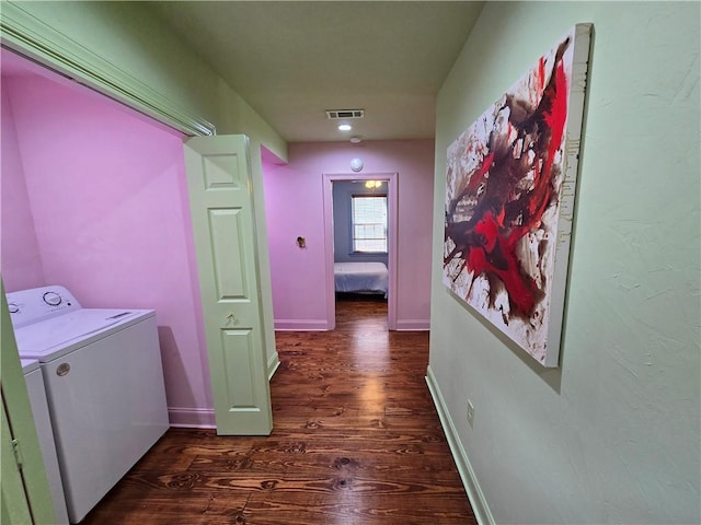 hall with separate washer and dryer and dark wood-type flooring