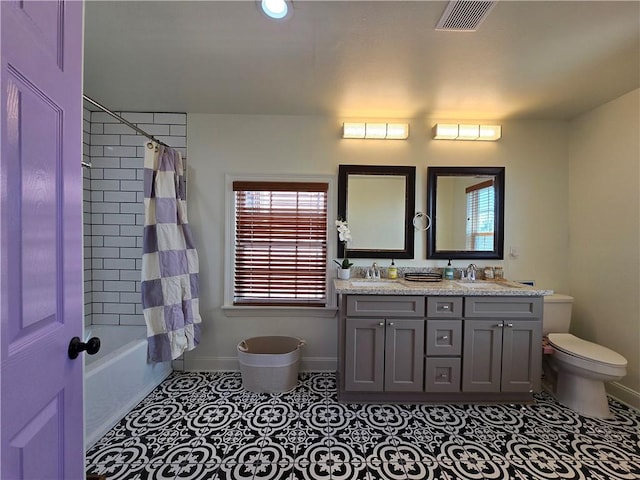 full bathroom with vanity, shower / tub combo, toilet, and tile patterned flooring