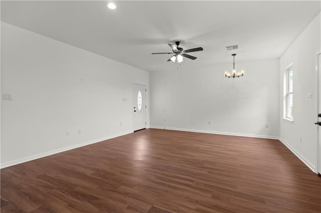 empty room featuring dark wood-type flooring and ceiling fan with notable chandelier