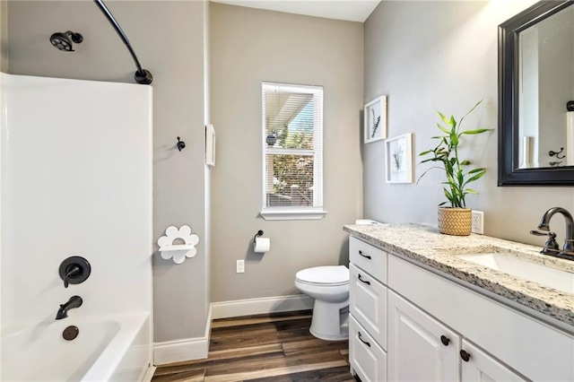 full bathroom with shower / washtub combination, hardwood / wood-style flooring, vanity, and toilet