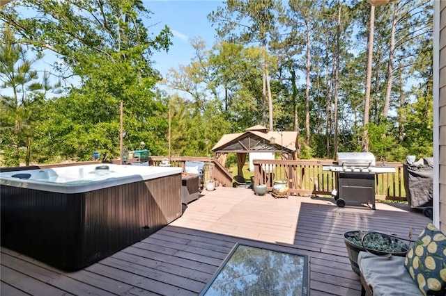 wooden terrace with a hot tub and grilling area