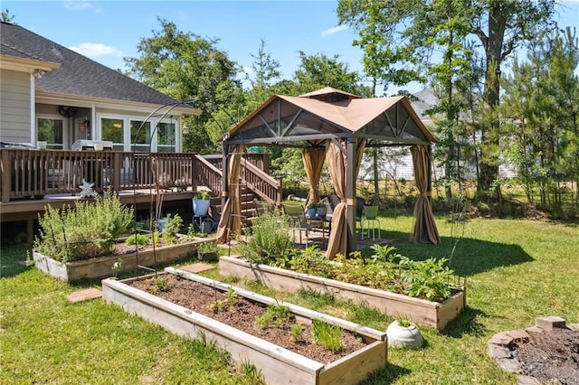 view of playground with a wooden deck, a gazebo, and a lawn