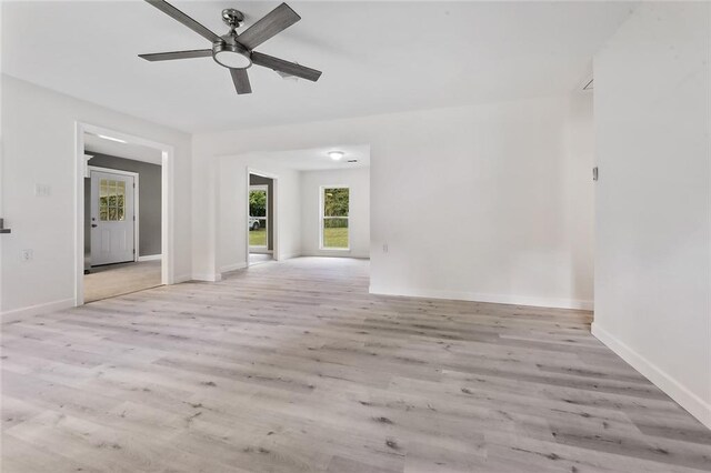 empty room with light hardwood / wood-style floors and ceiling fan