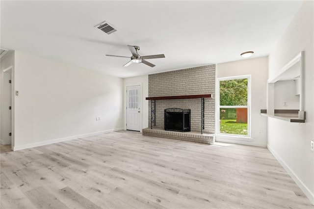 unfurnished living room with a fireplace, visible vents, ceiling fan, wood finished floors, and baseboards