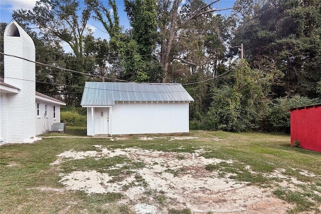 view of yard featuring a storage shed, central AC unit, and an outdoor structure