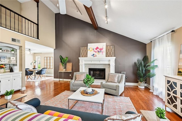 living room featuring plenty of natural light, high vaulted ceiling, and light wood-type flooring