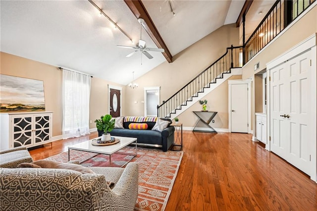 living room featuring beam ceiling, ceiling fan, high vaulted ceiling, track lighting, and hardwood / wood-style flooring