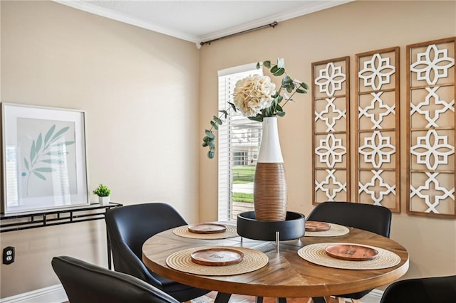 dining space with crown molding