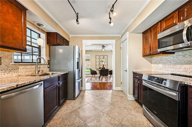 kitchen featuring decorative backsplash, sink, stainless steel appliances, and decorative light fixtures