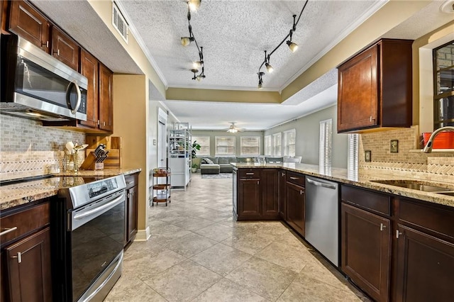 kitchen with kitchen peninsula, a textured ceiling, stainless steel appliances, and backsplash