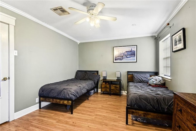 bedroom featuring ceiling fan, light hardwood / wood-style flooring, and crown molding