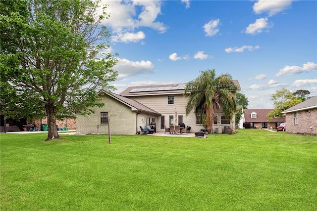 back of house featuring a yard and a patio