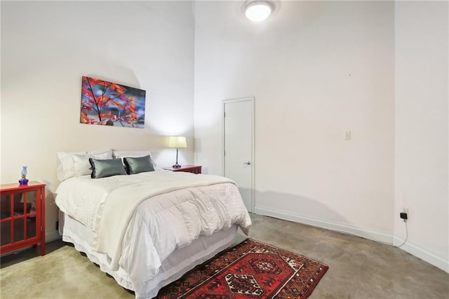 carpeted bedroom featuring a high ceiling