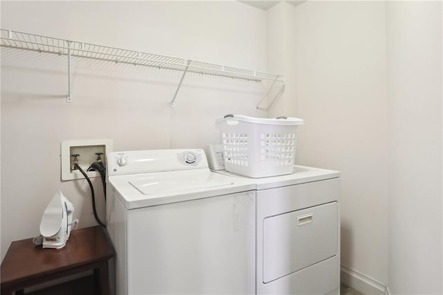 clothes washing area featuring washer and clothes dryer