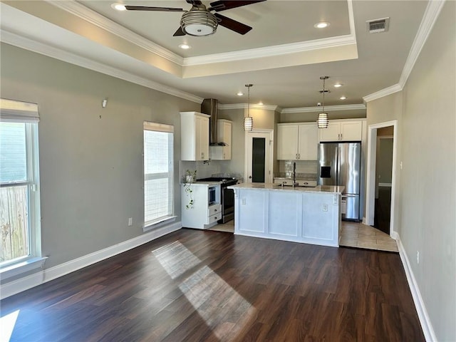 kitchen with white cabinetry, wall chimney exhaust hood, stainless steel appliances, dark hardwood / wood-style flooring, and a center island with sink