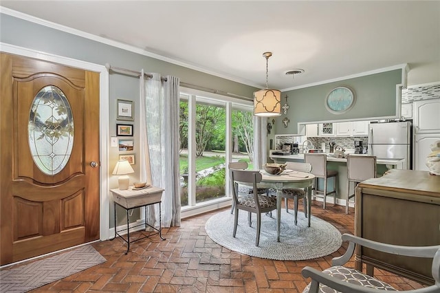 dining area with crown molding