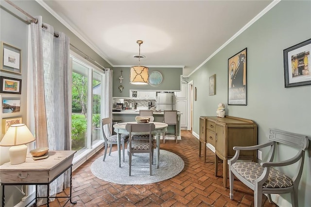 dining area featuring crown molding